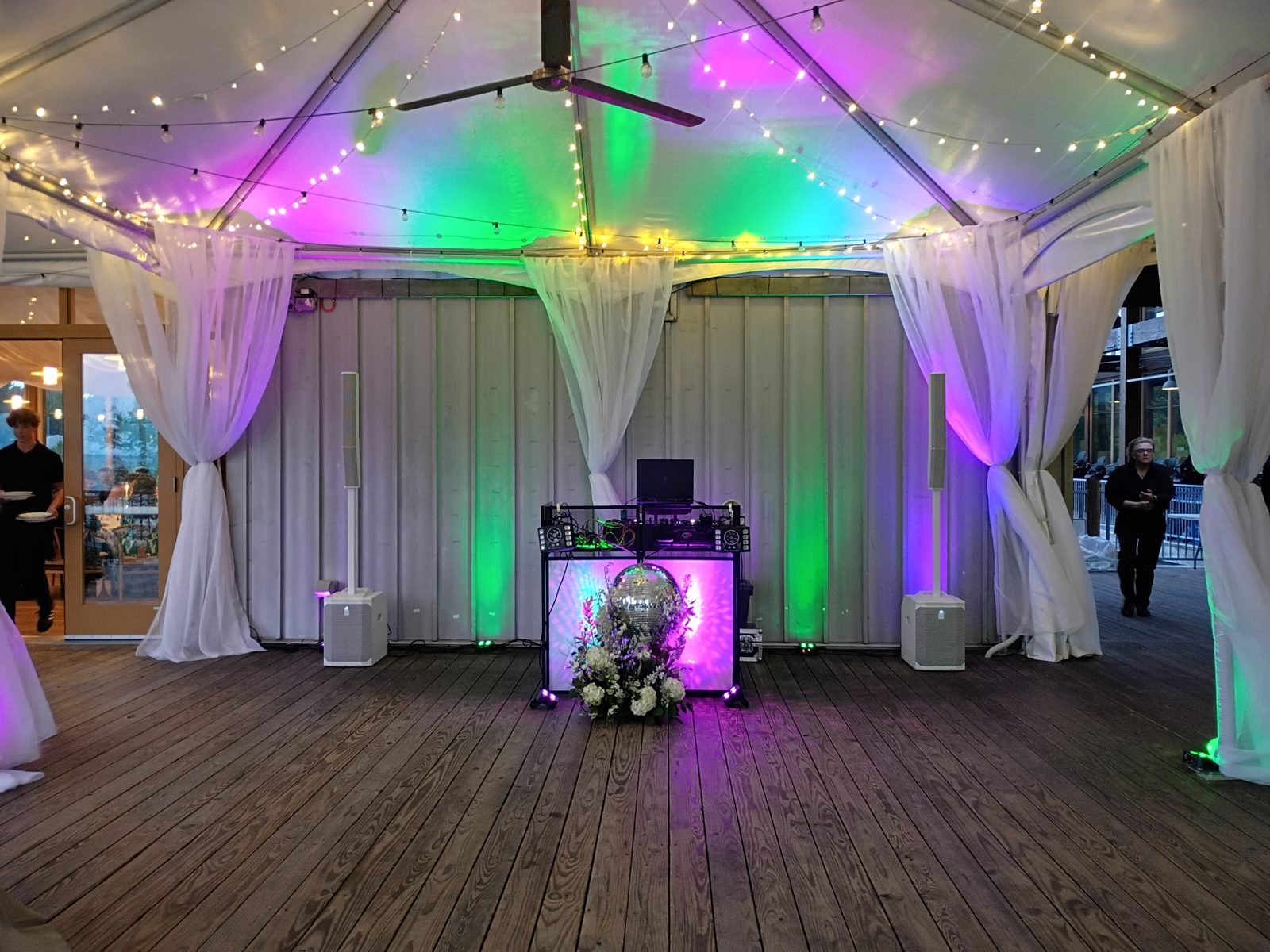 DJ Ray's booth under a tent with uplighting and string lights at the Chesapeake Bay Foundation in Annapolis